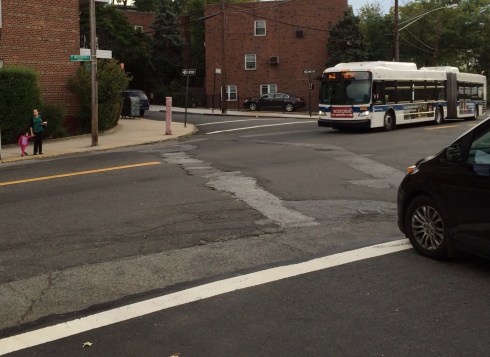 Heading to Kingsbridge Heights Community Center, Yalitza Perez and her 2-year-old daughter (upper left) begin their cross of Fort Independence Street where there are no crossing guards, crosswalks, stop signs, or traffic lights. (Photo: Jordan Moss)